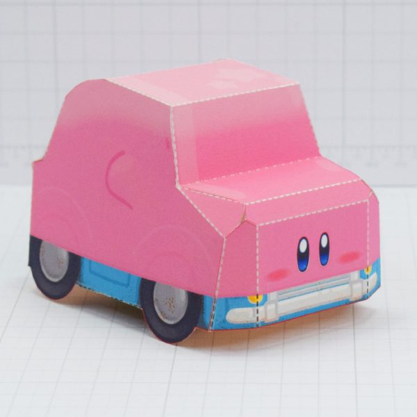 A photo of a paper toy of Kirby in 'mouthful mode' from the game Kirby and the Forgotten Land. This mode has been dubbed 'Karby' by online fans.