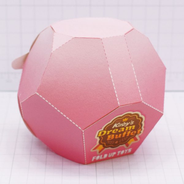 A photo of the Kirby's Dream Buffet paper toy once built, taken from the back, showing the game's logo.