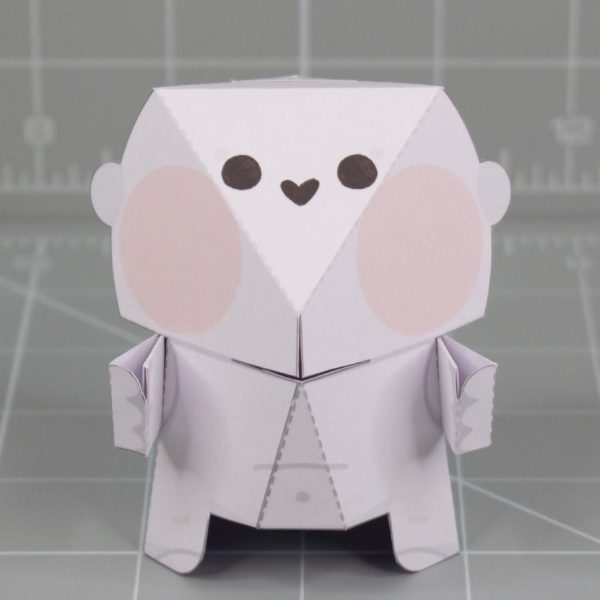 A photo of a Fold Up Friends papercraft. The design has a cute shape with a large head and small face.