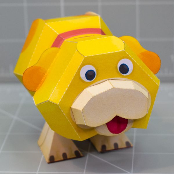A photo of a papercraft depicting Oatchi, a yellow space dog with 2 legs and no nose from the upcoming Pikmin 4 game. The photo is taken from the front.