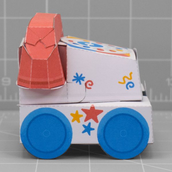 A photo of a papercraft depicting a retro children's toy phone. The papertoy has a cute face with an adorable smile.