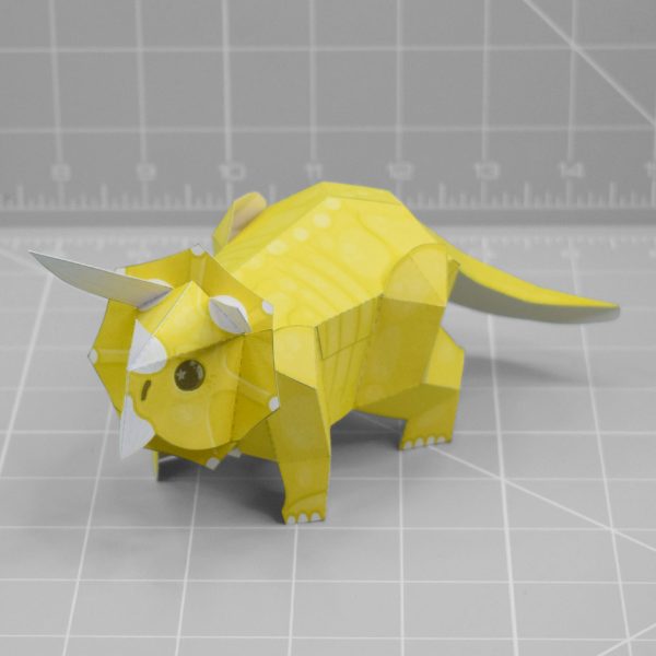 A photo of a yellow triceratops papercraft