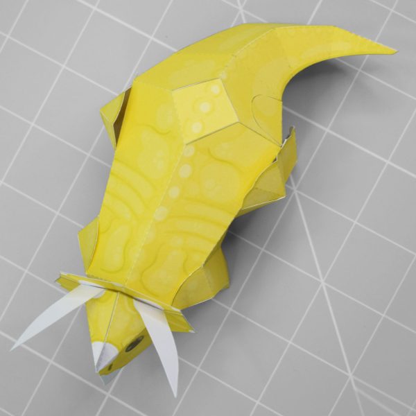 A photo of a yellow triceratops papercraft