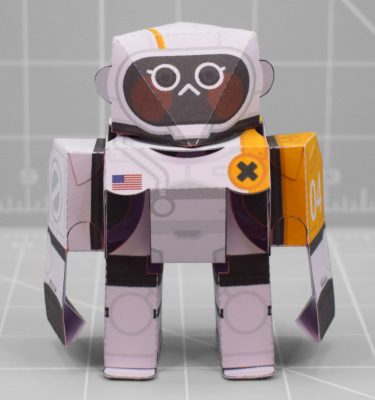 A photo of a white and orange papercraft robot with 5 points of articulation.