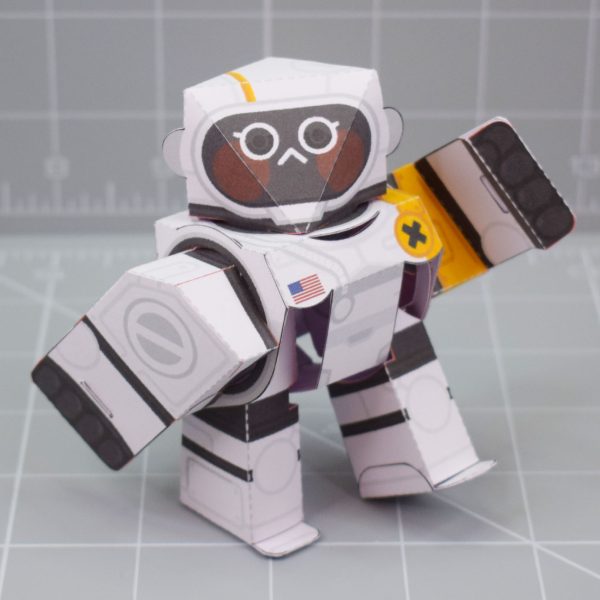 A photo of a white and orange papercraft robot with 5 points of articulation.